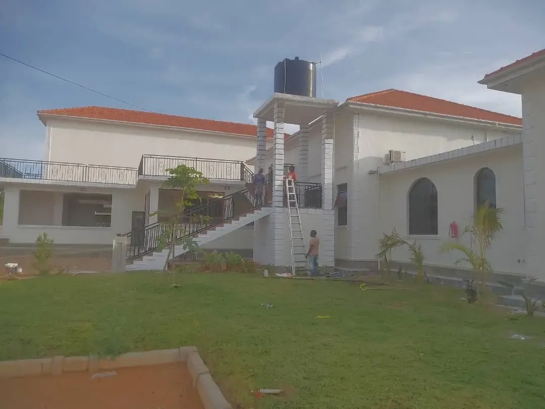 Construction team finishing touches on large residential mansion